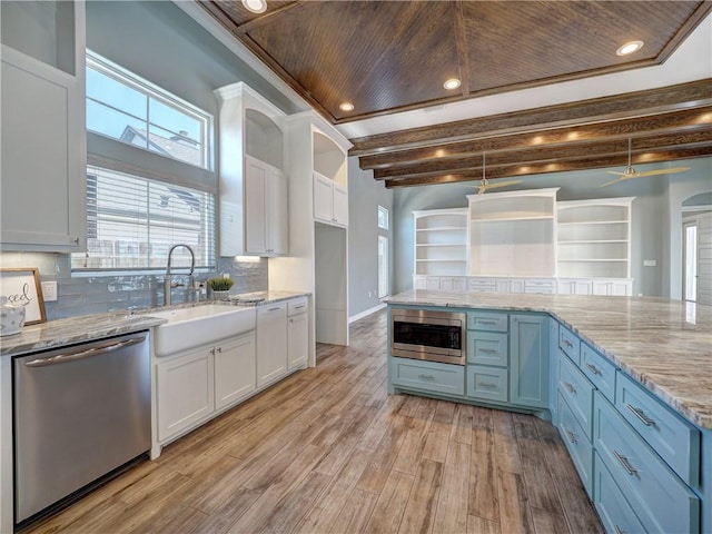 kitchen with light wood-style flooring, white cabinetry, a sink, and appliances with stainless steel finishes