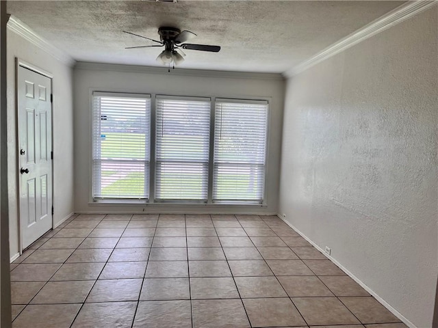 unfurnished room featuring ceiling fan, light tile patterned floors, and ornamental molding