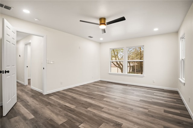 empty room with dark hardwood / wood-style floors and ceiling fan