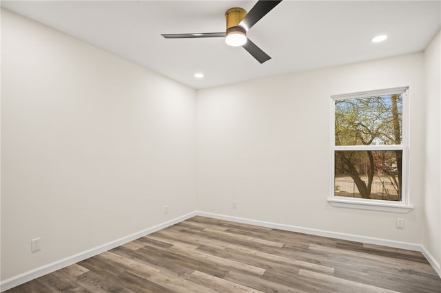 empty room featuring ceiling fan and hardwood / wood-style floors