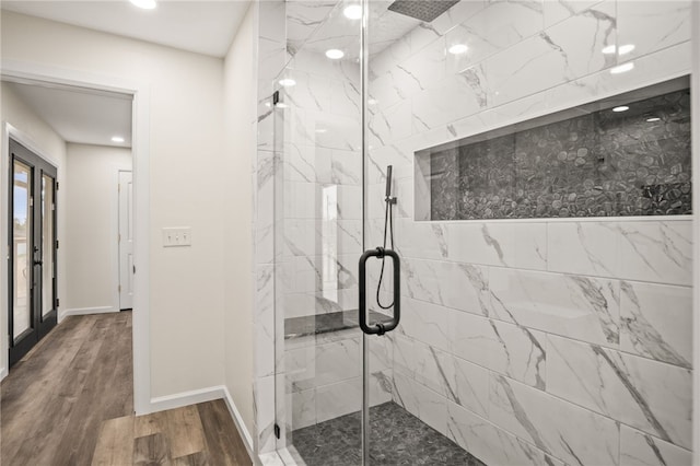 bathroom with walk in shower and wood-type flooring