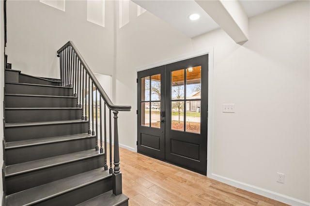 entryway with hardwood / wood-style flooring and french doors