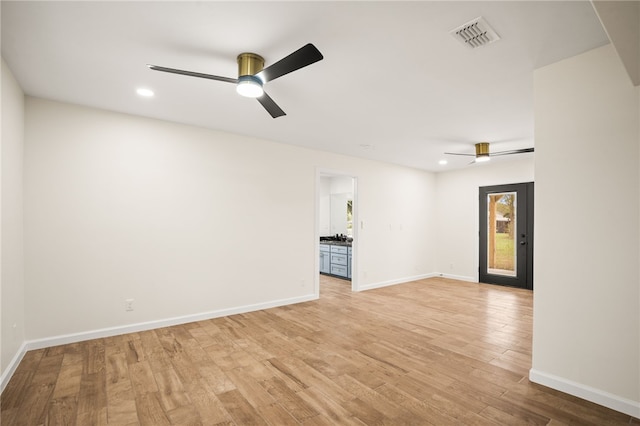 unfurnished room featuring ceiling fan and light wood-type flooring