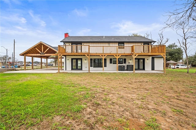 back of house featuring cooling unit, a lawn, a deck, and a patio area