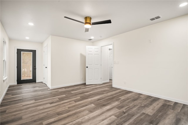 spare room featuring dark hardwood / wood-style flooring and ceiling fan