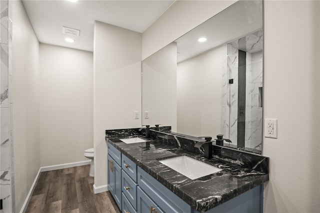 bathroom featuring vanity, wood-type flooring, and toilet