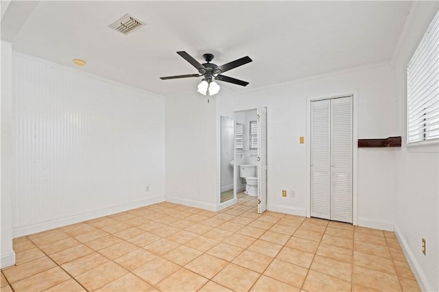 3101 Sylvan Crest Dr, Corpus Christi, TX 78415 - unfurnished bedroom with ceiling fan, crown molding, light tile patterned floors, and connected bathroom