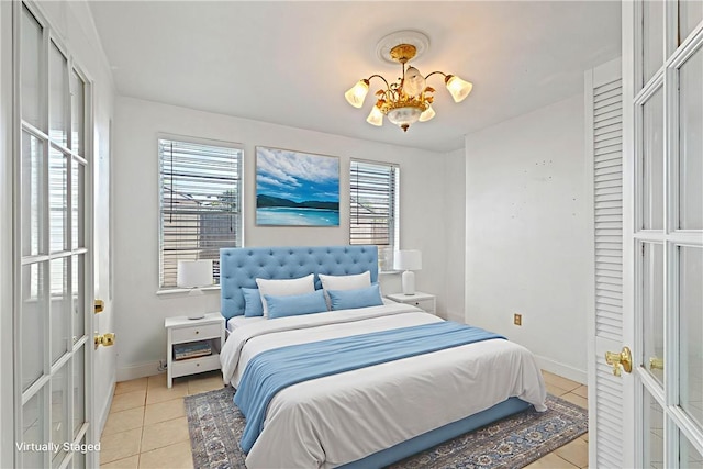 3101 Sylvan Crest Dr, Corpus Christi, TX 78415 - bedroom with light tile patterned floors and a chandelier