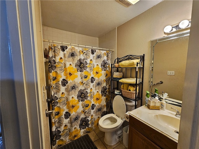 bathroom with a textured ceiling, curtained shower, vanity, tile patterned floors, and toilet