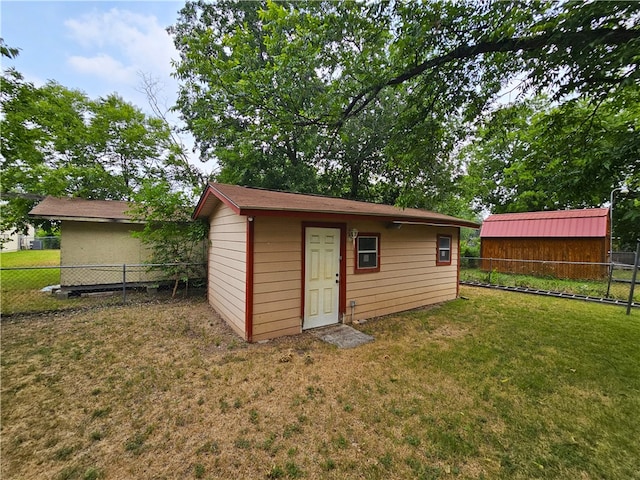 view of outbuilding featuring a yard