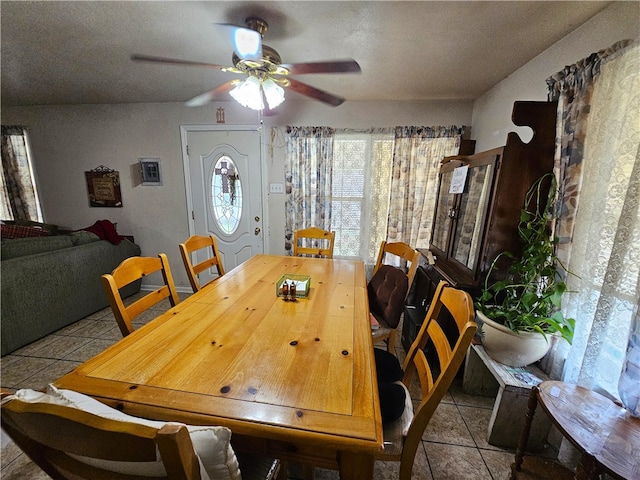 tiled dining area featuring ceiling fan