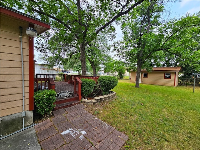 view of yard with a wooden deck and an outdoor structure