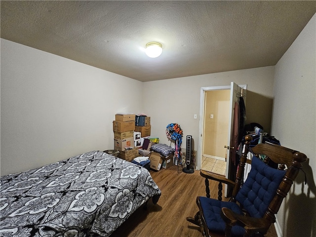 bedroom featuring dark wood-type flooring and a textured ceiling