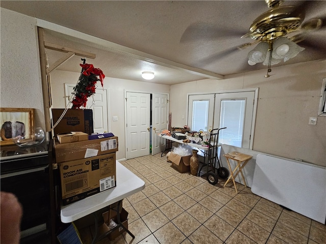 misc room with ceiling fan, a textured ceiling, tile patterned flooring, and french doors