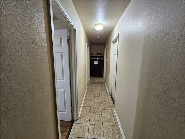 corridor featuring a textured ceiling