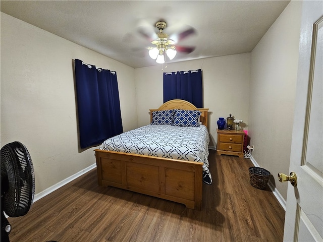 bedroom with ceiling fan and dark hardwood / wood-style floors