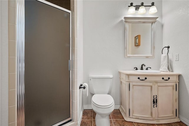 109 Tarpon Ct, Aransas Pass, TX 78336 - bathroom featuring a stall shower, toilet, vanity, and baseboards