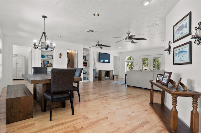 109 Tarpon Ct, Aransas Pass, TX 78336 - dining room featuring built in features, light wood-style floors, ceiling fan, and a chandelier