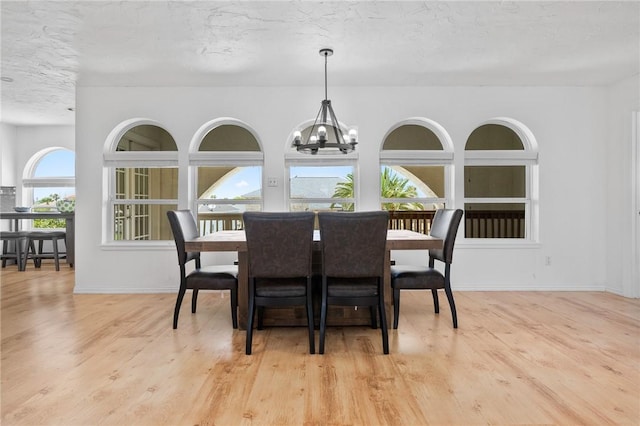 109 Tarpon Ct, Aransas Pass, TX 78336 - dining area with wood finished floors, a chandelier, and baseboards