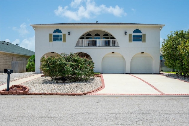 109 Tarpon Ct, Aransas Pass, TX 78336 - view of front of home featuring a garage, driveway, stucco siding, and a balcony