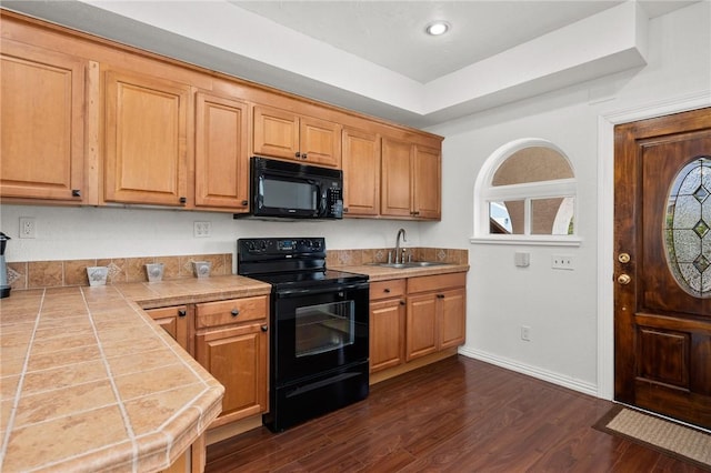 109 Tarpon Ct, Aransas Pass, TX 78336 - kitchen with black appliances, tile counters, dark wood-style flooring, baseboards, and a sink