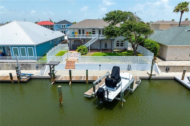 109 Tarpon Ct, Aransas Pass, TX 78336 - dock featuring boat lift, a fenced backyard, stairs, and a residential view