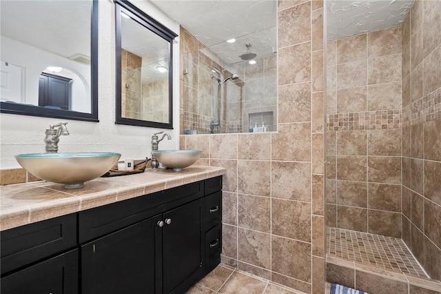 109 Tarpon Ct, Aransas Pass, TX 78336 - full bathroom with double vanity, a walk in shower, tile walls, and tile patterned floors