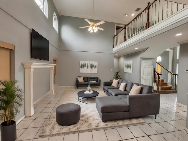 4513 Ammer Lake Dr, Corpus Christi, TX 78413 - tiled living room with a towering ceiling, a ceiling fan, crown molding, and stairs