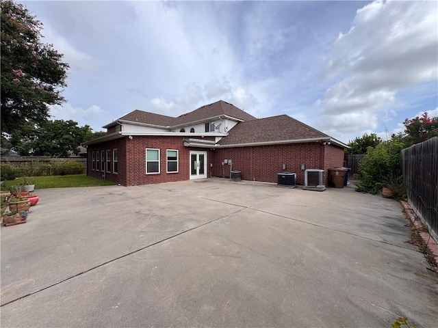 4513 Ammer Lake Dr, Corpus Christi, TX 78413 - back of property featuring brick siding, french doors, a fenced backyard, a patio area, and driveway