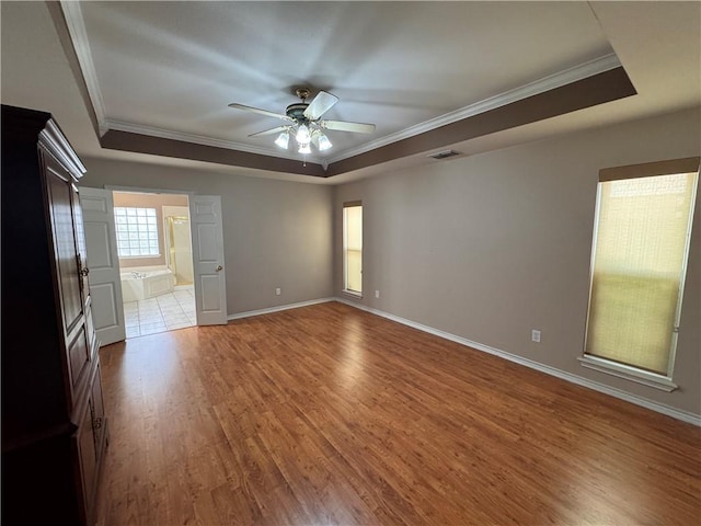 4513 Ammer Lake Dr, Corpus Christi, TX 78413 - unfurnished room with a raised ceiling, ornamental molding, ceiling fan, and wood finished floors
