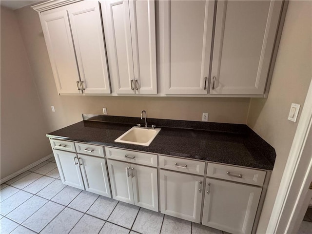 4513 Ammer Lake Dr, Corpus Christi, TX 78413 - kitchen with white cabinets, light tile patterned flooring, and dark stone countertops