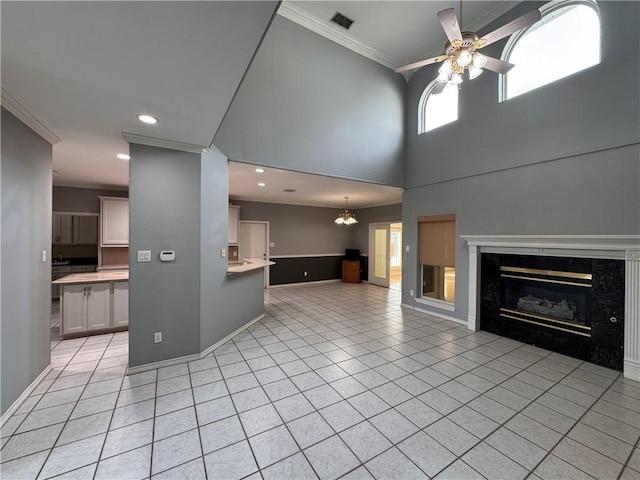 4513 Ammer Lake Dr, Corpus Christi, TX 78413 - unfurnished living room with ornamental molding, light tile patterned floors, a premium fireplace, a ceiling fan, and recessed lighting
