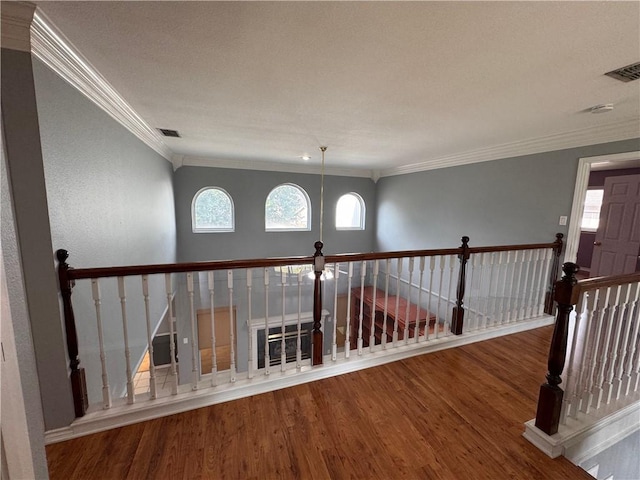 4513 Ammer Lake Dr, Corpus Christi, TX 78413 - hallway featuring ornamental molding, wood finished floors, and an upstairs landing