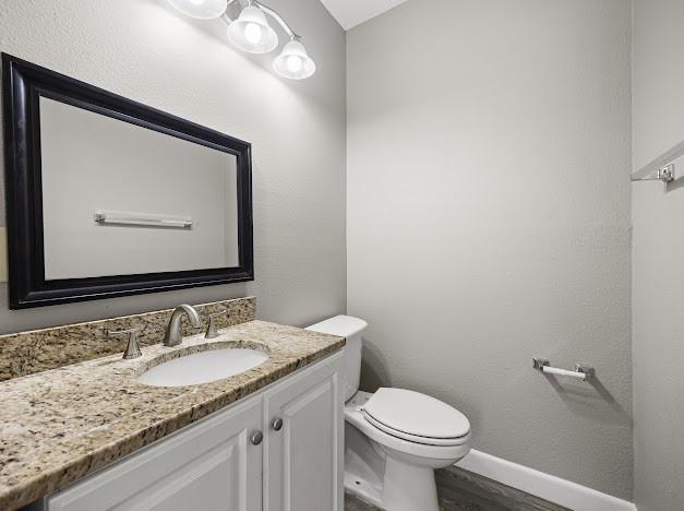 6022 Norvel Dr, Corpus Christi, TX 78412 - half bathroom with vanity and wood finished floors