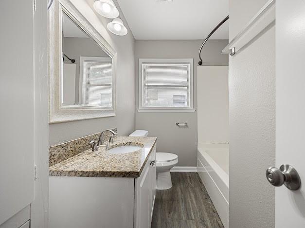 6022 Norvel Dr, Corpus Christi, TX 78412 - bathroom with wood finished floors, vanity, and shower / tub combination