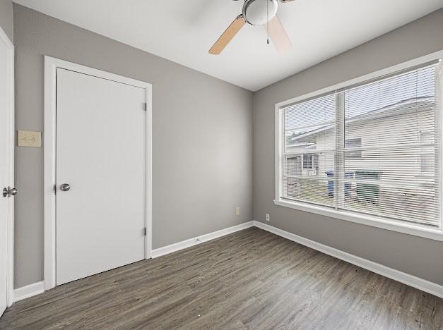 6022 Norvel Dr, Corpus Christi, TX 78412 - unfurnished bedroom featuring wood finished floors and a ceiling fan
