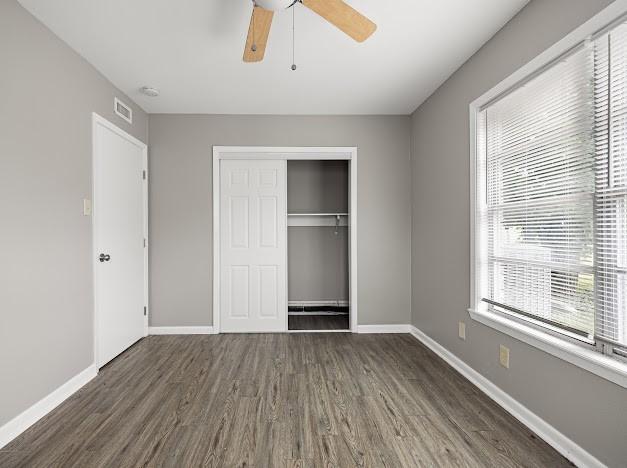 6022 Norvel Dr, Corpus Christi, TX 78412 - unfurnished bedroom featuring wood finished floors, a closet, and ceiling fan