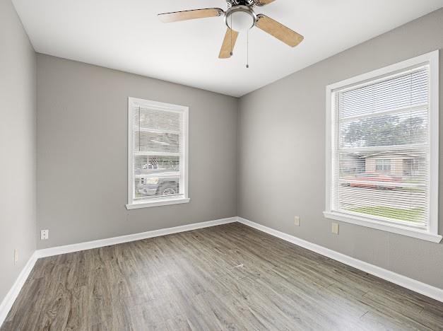 6022 Norvel Dr, Corpus Christi, TX 78412 - unfurnished room with healthy amount of natural light, wood finished floors, and ceiling fan