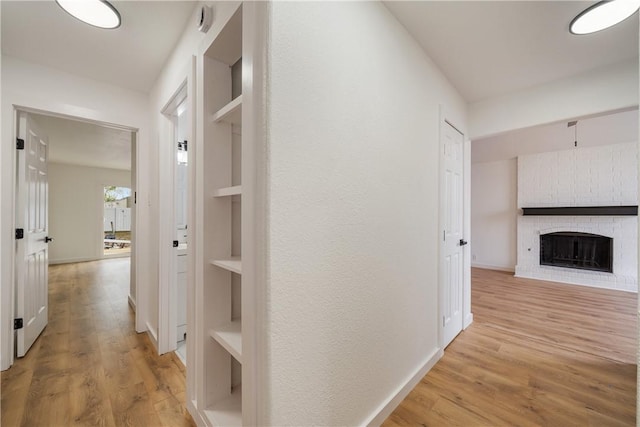 2442 Bevecrest Dr, Corpus Christi, TX 78415 - hallway featuring light wood finished floors, baseboards, and built in features