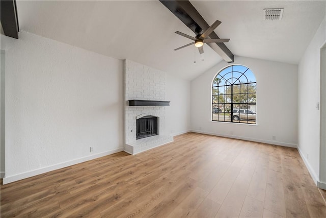 2442 Bevecrest Dr, Corpus Christi, TX 78415 - unfurnished living room featuring ceiling fan, visible vents, vaulted ceiling with beams, a fireplace, and wood finished floors