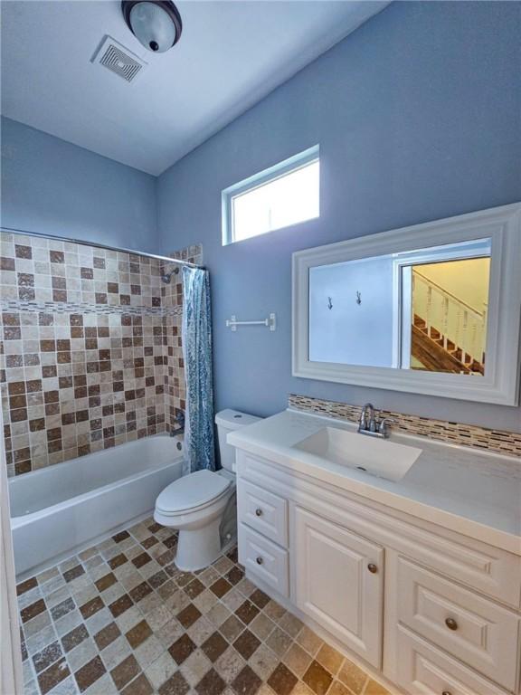 full bathroom featuring vanity, toilet, and shower / tub combo