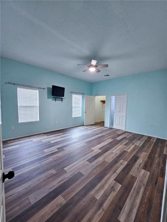 interior space featuring ceiling fan and dark hardwood / wood-style flooring