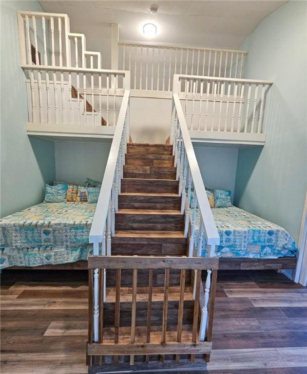 bedroom with dark hardwood / wood-style flooring