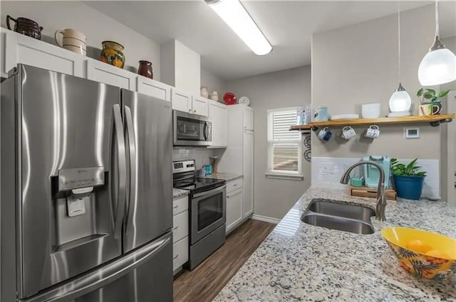 kitchen featuring stainless steel appliances, white cabinetry, and sink