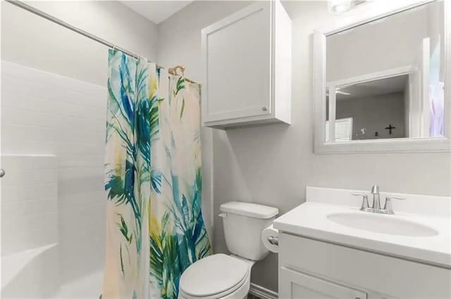 bathroom featuring walk in shower, vanity, and toilet