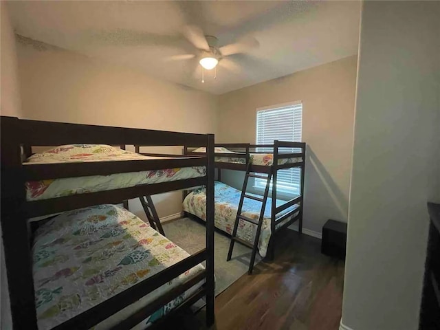 bedroom with ceiling fan and dark hardwood / wood-style flooring