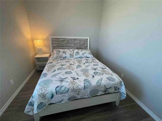 bedroom with dark wood-type flooring