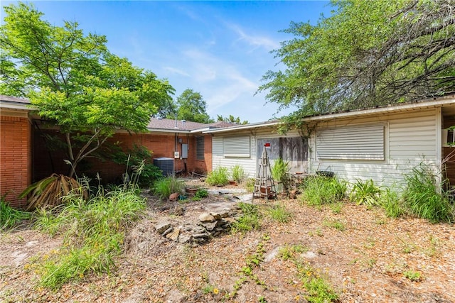 1325 S Whitney St, Aransas Pass, TX 78336 - exterior space with brick siding and central AC unit