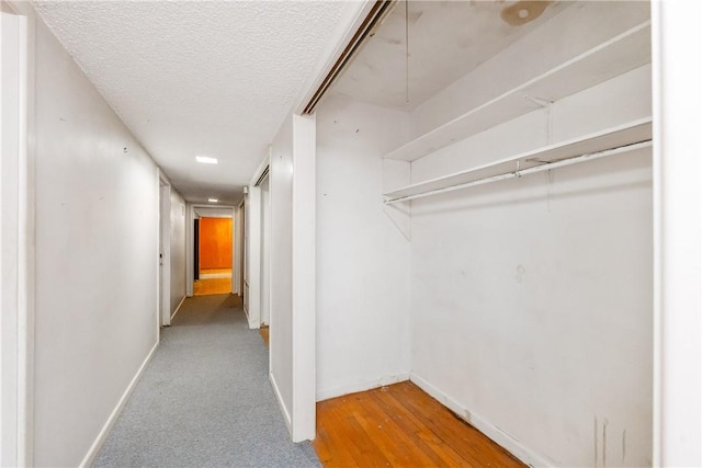 1325 S Whitney St, Aransas Pass, TX 78336 - corridor featuring a textured ceiling, wood finished floors, and baseboards