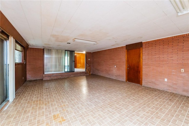 1325 S Whitney St, Aransas Pass, TX 78336 - spare room with brick patterned floor and brick wall